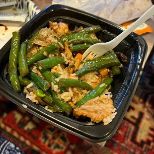 a person holding a bowl of food