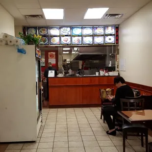 a woman sitting at a table in a restaurant
