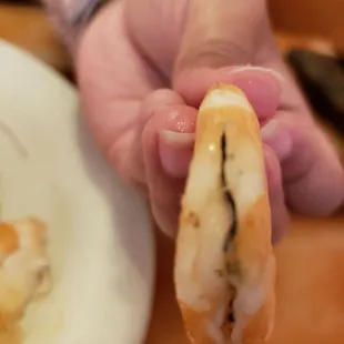 a person holding a piece of food