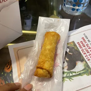 a hand holding a piece of food