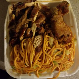 a take out container of chicken and noodles