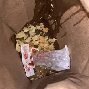 a brown paper bag filled with food