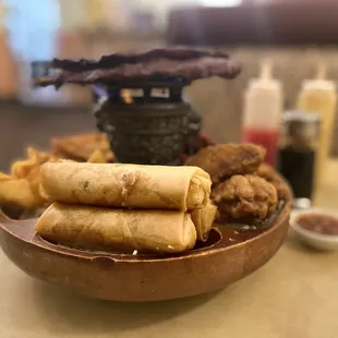 a plate of fried food and dipping sauces