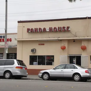 two cars parked in front of the restaurant