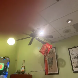 a ceiling fan with a chinese lantern hanging from the ceiling