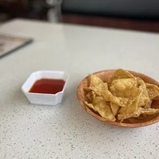 Complimentary fried wonton chips with sweet &amp; sour sauce