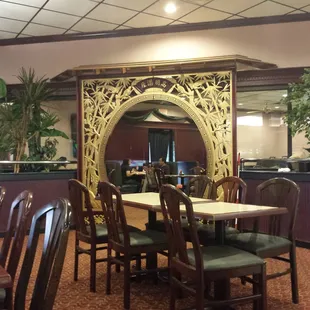 a dining room with a large mirror