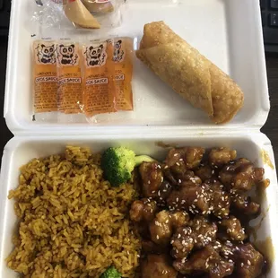 a tray of food with rice, broccoli, and a roll