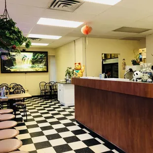 a panda sitting at the counter