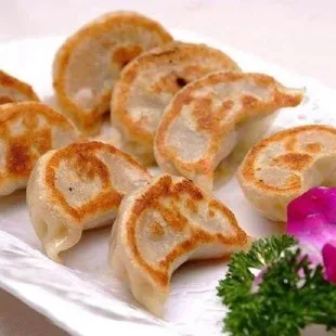 a plate of dumplings and a flower
