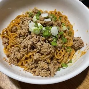 a plate of noodles and meat