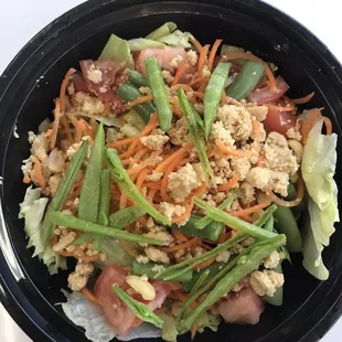 a salad in a black bowl