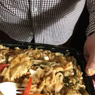 a man holding a tray of food