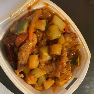 a takeout container of a chinese dish