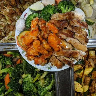 a plate of chicken, broccoli, and carrots