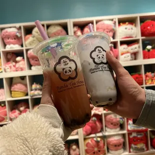 a hand holding a cup of iced tea