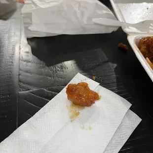 Orange chicken with metal on it