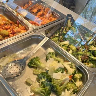 Wilted looking veggies, orange chicken and Fried Rice way in the back.