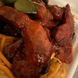 a plate of noodles and meat