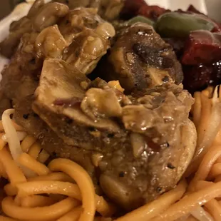 a plate of noodles and meat