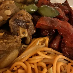 noodles, meat, and vegetables in a styrofoam container