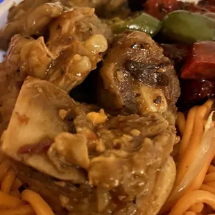 a plate of noodles with meat and vegetables