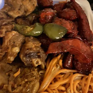 a plate of noodles and meat