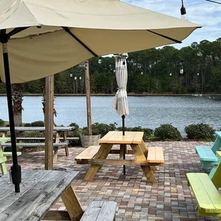 picnic tables and umbrellas on a brick patio
