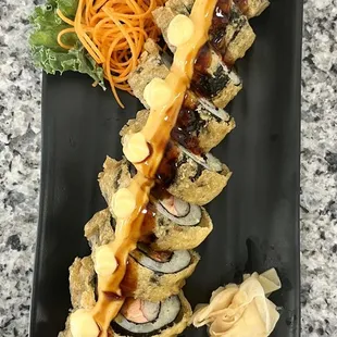 a plate of sushi with sauce