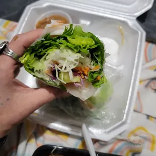 a hand holding a sandwich