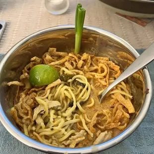 Thai Spicy Kao Soi noodles  !! Savory yellow curry with egg noodles and pork. It's the jam.