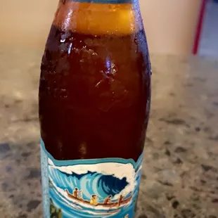 a bottle of beer sitting on a counter