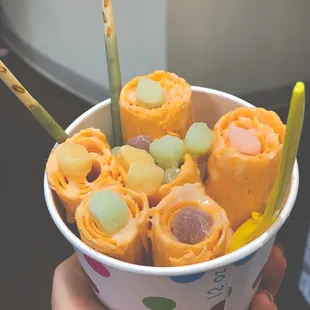 Thai tea base with sweetened condensed milk, rainbow mochi, and matcha pocky