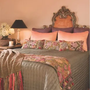 hand-stitched Habotai silk reversible quilt from Vietnam, &amp; hand made embroidered pillows and runners from Peruvian cooperative.