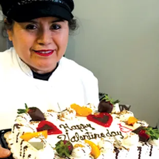 a woman holding a birthday cake