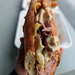 Slow roasted beef, fermented butter, pickled banana peppers, aioli on a baguette.  Top tier sandwich