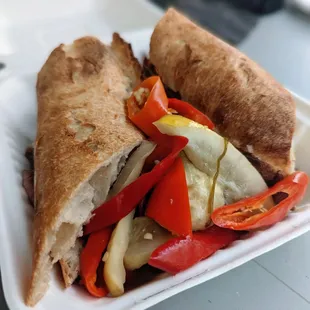 Roast beef sandwich. With pickled banana peppers and cucumbers, onions and garlic.