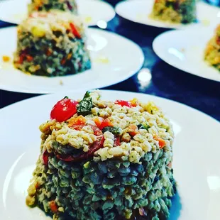 a plate of risoped rice with tomatoes