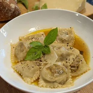 a bowl of ravierole and bread