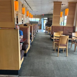 a boy sitting on a bench in a restaurant