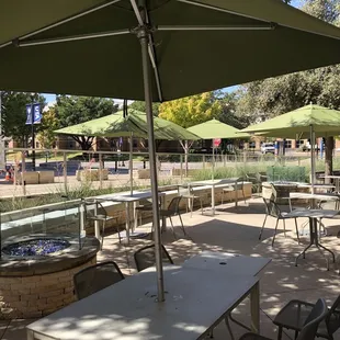 tables and chairs with umbrellas