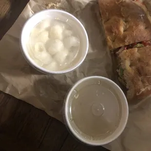 two cups of soup and a sandwich