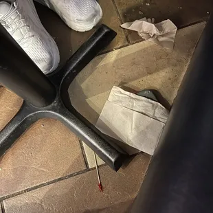 Trash all over the floor beneath the table.