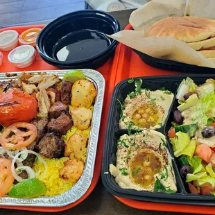 3 person platter.  Comes with Beef Kabab, Chicken Kabab, Kufta Kabab, chicken shawarma, hummus, rice, salad, and fresh-baked pitas.