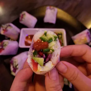 a person holding a small piece of food