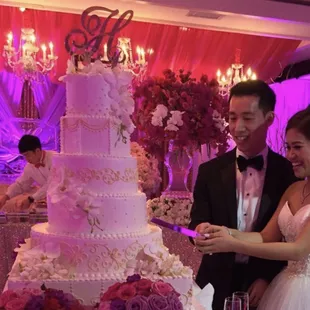 Our 6 tiered wedding cake made with three flavors , white cake with strawberry cream, raspberry and mocha.