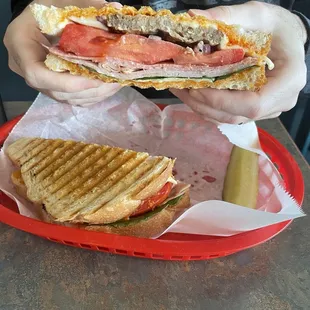 a person holding a sandwich