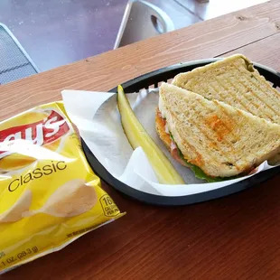 A bag of chips and pickle are included with your sandwich