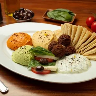 Appetizer Combo: Garbanzo, spicy, and edamame hummus, caprese, tzatziki, and falafels made to order.