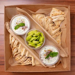 Tzatziki Catering Tray: Tzatziki spread along with pita bread and cucumber slices